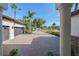 Paved driveway leading to a three-car garage with palm trees and landscaping at 25459 Hawks Run Ln, Sorrento, FL 32776