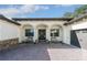 Welcoming front entrance with double doors, arched entryway, and charming porch at 25459 Hawks Run Ln, Sorrento, FL 32776