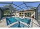 Backyard oasis with a screened-in pool, spa, and travertine pavers at 25459 Hawks Run Ln, Sorrento, FL 32776