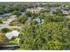 Aerial view of a property with mature trees, a house, and neighboring homes at 3109 Williams St, Orlando, FL 32806