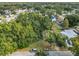 An aerial perspective of a property with trees, a house, and neighboring homes at 3109 Williams St, Orlando, FL 32806