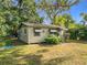 Charming single-story home with green trim and a spacious front yard at 3109 Williams St, Orlando, FL 32806