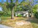 One-story home nestled amidst mature trees and lush greenery at 3109 Williams St, Orlando, FL 32806