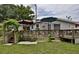 Backyard deck with pergola, umbrella, and lush green lawn at 431 Perdita Ave, Edgewater, FL 32132
