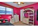 Bright bedroom with pink walls and ample storage at 431 Perdita Ave, Edgewater, FL 32132