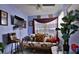 Cozy living room featuring a sleeper sofa and large plant at 431 Perdita Ave, Edgewater, FL 32132
