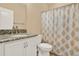 Bathroom with granite countertop, white cabinets, and shower at 440 Alcove Dr, Groveland, FL 34736