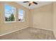 Spacious bedroom with neutral walls, carpet, and two windows at 440 Alcove Dr, Groveland, FL 34736