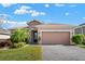 One-story home with stone accents and landscaped yard at 440 Alcove Dr, Groveland, FL 34736