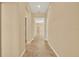 Light and bright hallway with tile flooring at 440 Alcove Dr, Groveland, FL 34736