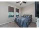 Bedroom with carpeted floors, two windows, and ceiling fan at 4902 Soft Rush St, Orlando, FL 32811