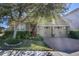 Inviting front yard with a two-car garage and a well-maintained landscaped garden at 4902 Soft Rush St, Orlando, FL 32811