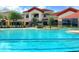 Community pool with clubhouse in background; inviting pool area at 513 San Sebastian Ct, Davenport, FL 33837