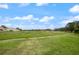 Open green space with mature trees and landscaping at 707 Carpenters Way # 45, Lakeland, FL 33809