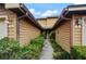 Condo entry with walkway and well-maintained landscaping at 707 Carpenters Way # 45, Lakeland, FL 33809