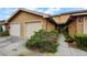 Tan two-story townhome with attached garage and walkway at 707 Carpenters Way # 45, Lakeland, FL 33809