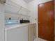 Laundry room with washer, dryer and storage shelves at 707 Carpenters Way # 45, Lakeland, FL 33809