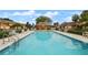 Community pool with surrounding patio furniture at 707 Carpenters Way # 45, Lakeland, FL 33809