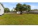 Large grassy backyard with shed and trees at 805 Melody Dr, Chuluota, FL 32766