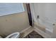 Bathroom with shower/tub combo, toilet, and window with blinds at 8252 Civita Dr # 201, Davenport, FL 33896