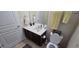 Bathroom with single vanity, toilet, and dark wood cabinets at 8252 Civita Dr # 201, Davenport, FL 33896