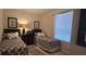 Bedroom with two twin beds, nightstands, and a window at 8252 Civita Dr # 201, Davenport, FL 33896