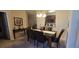 Dining room with dark wood table and chairs, and view of the kitchen at 8252 Civita Dr # 201, Davenport, FL 33896