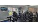 Well-equipped fitness center with weight machines, TVs, and large windows at 8252 Civita Dr # 201, Davenport, FL 33896
