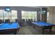 Game room with two pool tables, high-top tables, and decorative lighting at 8252 Civita Dr # 201, Davenport, FL 33896