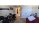 Home office with desk, chair, red couch, and storage at 8252 Civita Dr # 201, Davenport, FL 33896