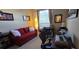 Home office with red couch, desk, chair and laptop at 8252 Civita Dr # 201, Davenport, FL 33896