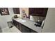 Kitchen with dark wood cabinets, light countertops, and stainless steel appliances at 8252 Civita Dr # 201, Davenport, FL 33896