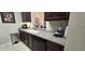 Kitchen with dark wood cabinets, light countertops, and stainless steel appliances at 8252 Civita Dr # 201, Davenport, FL 33896