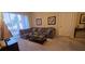 Living room featuring a sectional sofa, coffee table, and sliding glass door to balcony at 8252 Civita Dr # 201, Davenport, FL 33896