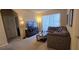 Living room with comfortable sectional sofa, entertainment center, and sliding glass doors at 8252 Civita Dr # 201, Davenport, FL 33896