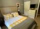 Bedroom with queen bed and yellow bedding at 902 Assembly Ct, Reunion, FL 34747