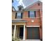 Two-story townhome with a two-car garage and columns at 902 Assembly Ct, Reunion, FL 34747