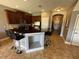 Kitchen boasts an island with seating and dark wood cabinets at 902 Assembly Ct, Reunion, FL 34747