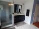 Bathroom with a glass shower, dark vanity, and tile floor at 915 Ekana Green Ct, Oviedo, FL 32765