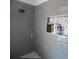 Modern gray tiled shower with built-in shelves and bench at 915 Ekana Green Ct, Oviedo, FL 32765