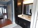 Bathroom vanity with dark wood cabinets, white countertop, and bronze fixtures at 915 Ekana Green Ct, Oviedo, FL 32765