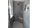 Modern shower featuring gray tile, built-in shelves, and bench seating at 915 Ekana Green Ct, Oviedo, FL 32765