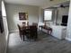Dining and living area with wooden dining table and access to backyard at 915 Ekana Green Ct, Oviedo, FL 32765