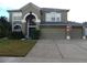 Two-story home with a two-car garage, landscaped yard, and an American flag at 915 Ekana Green Ct, Oviedo, FL 32765