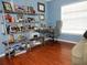 Home office with blue walls, wood floors, and filled bookshelves at 915 Ekana Green Ct, Oviedo, FL 32765
