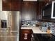 Kitchen features dark cabinets, stainless steel appliances, and white countertops at 915 Ekana Green Ct, Oviedo, FL 32765