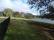 Private backyard with a serene lake view and mature trees at 915 Ekana Green Ct, Oviedo, FL 32765