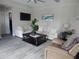 Spacious living area featuring white couch, armchairs, and large windows at 915 Ekana Green Ct, Oviedo, FL 32765