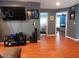 Living area with wood floors, entertainment center, and view of adjacent room at 915 Ekana Green Ct, Oviedo, FL 32765