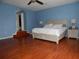Large main bedroom with wooden floors, ceiling fan, and ensuite bathroom access at 915 Ekana Green Ct, Oviedo, FL 32765